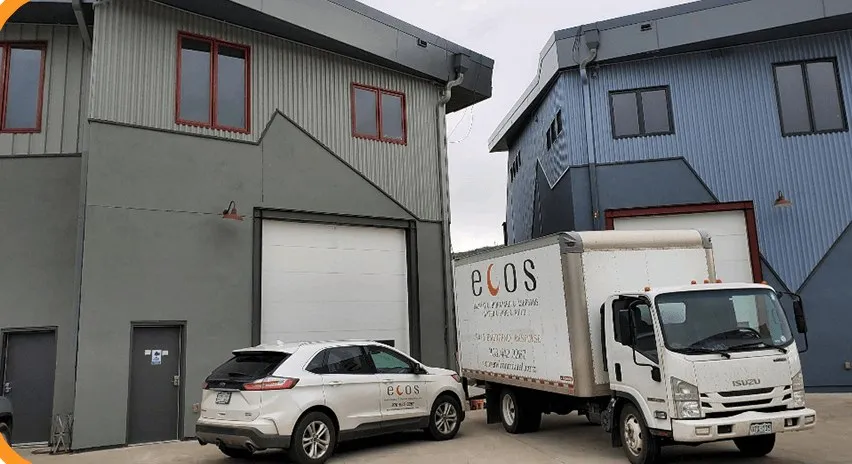 An ECOS box truck and company SUV outside an ECOS shop